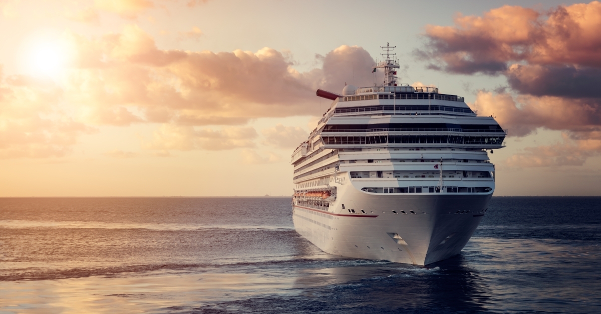 luxury cruise ship leaving port at sunset