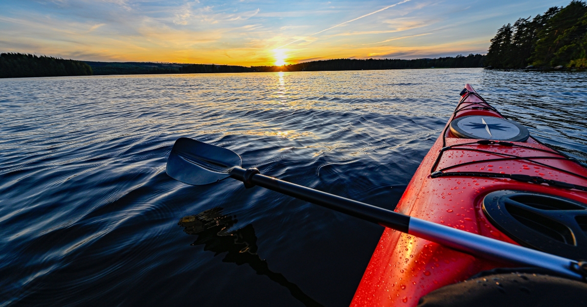 red plastic kayak on water
