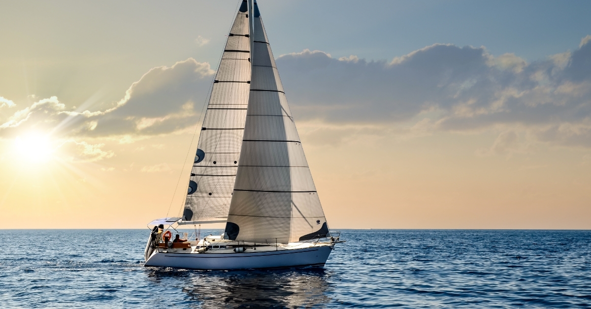 sailboat sailing under beautiful sunset