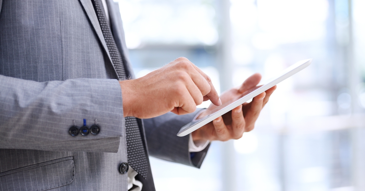 hands and tablet in office
