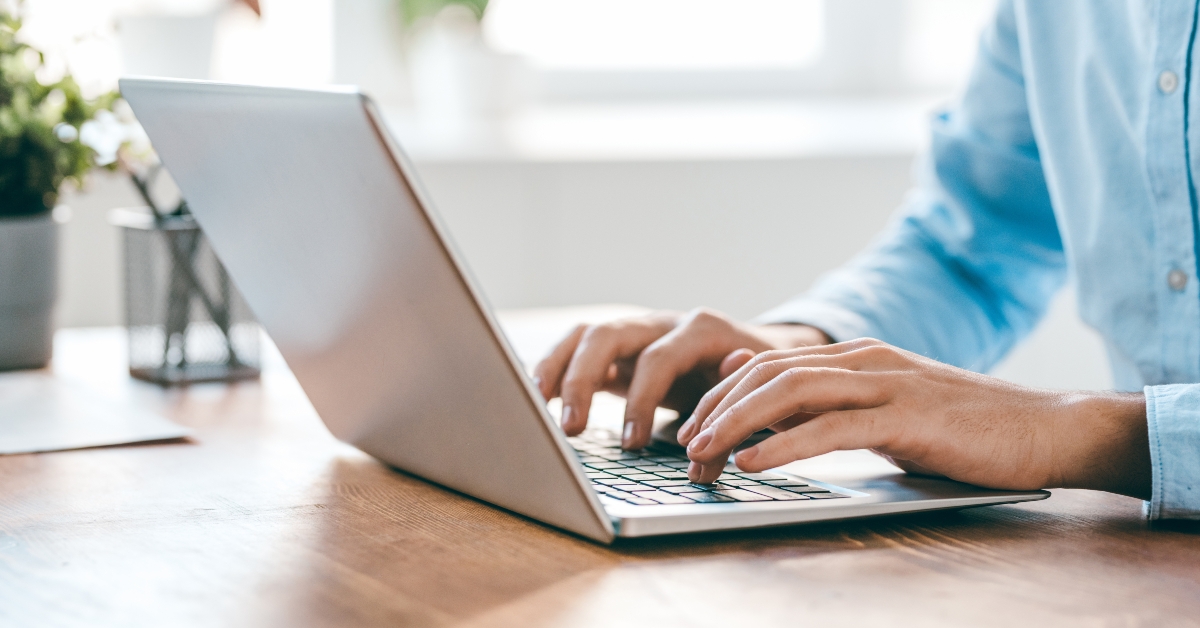 hands over laptop keypad