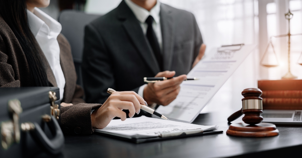 male and female lawyer discussing documents