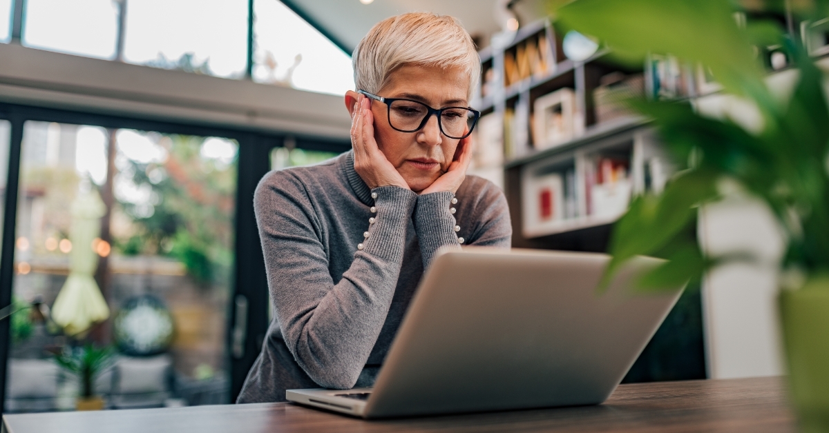 stressed senior woman using laptop