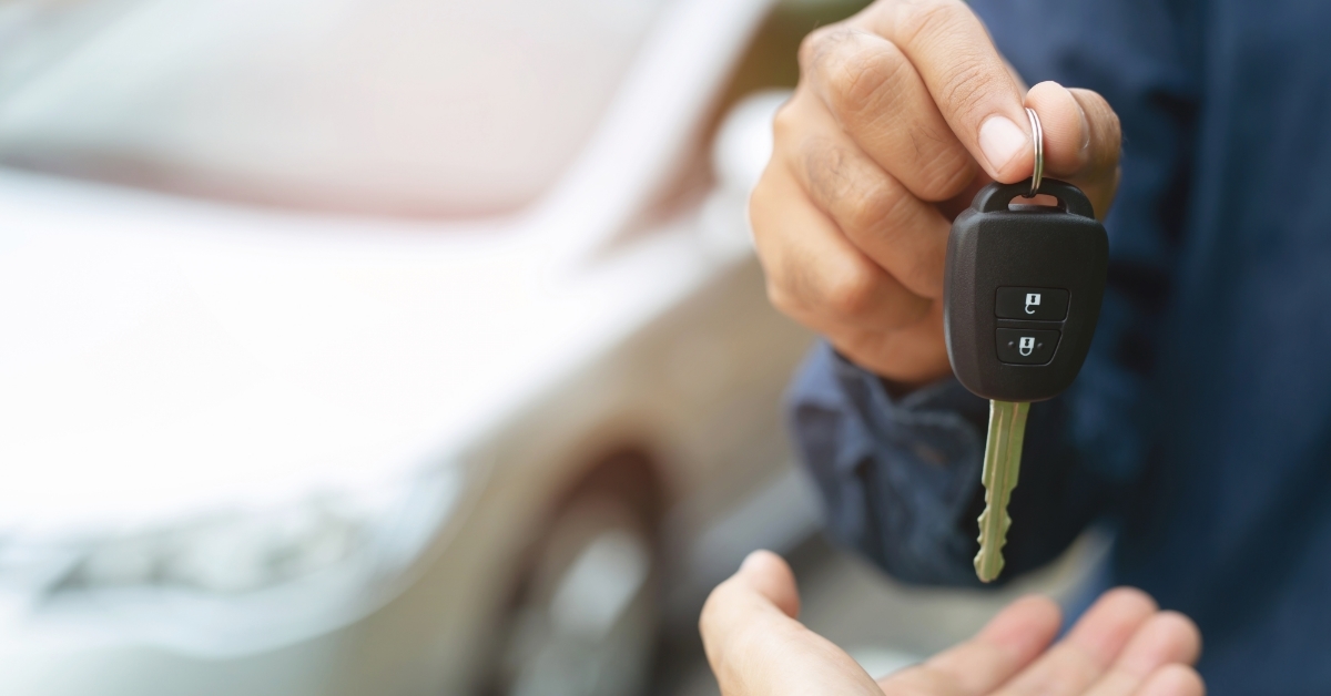 business man giving keys to client