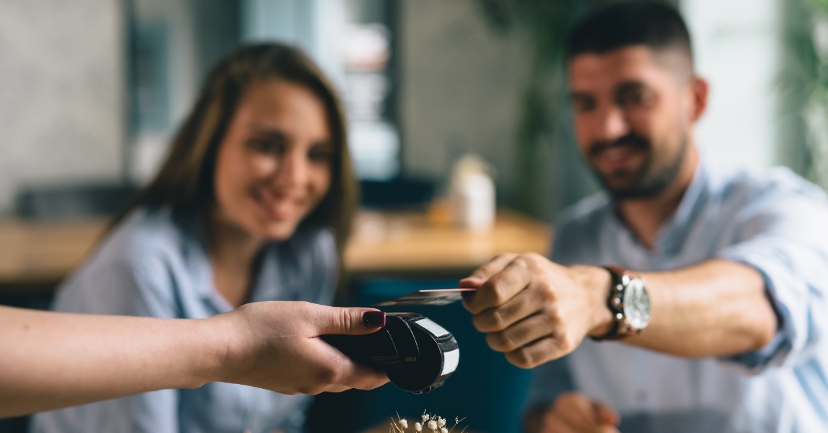 couple paying with card at restaurant