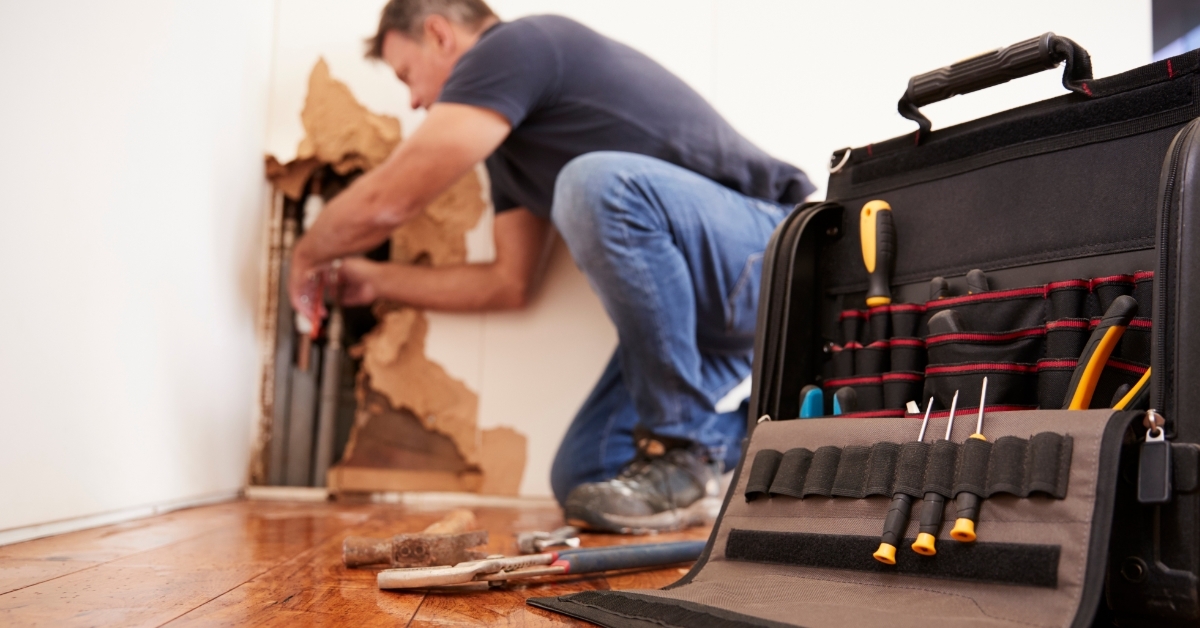 male plumber fixing pipelines at home