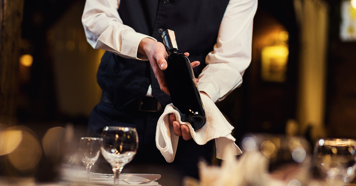 waiter offers visitors wine