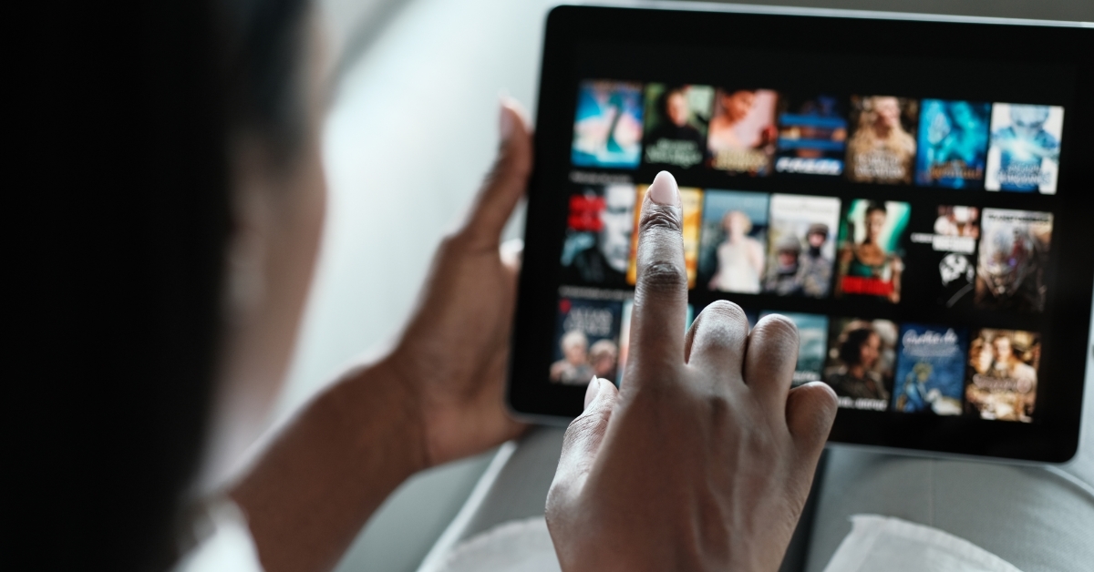 Woman Browsing streaming service on tablet