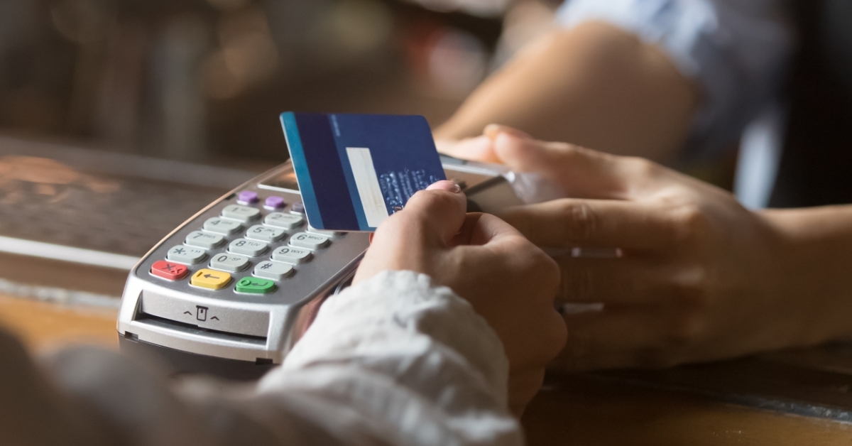 woman making contactless payment at restaurant