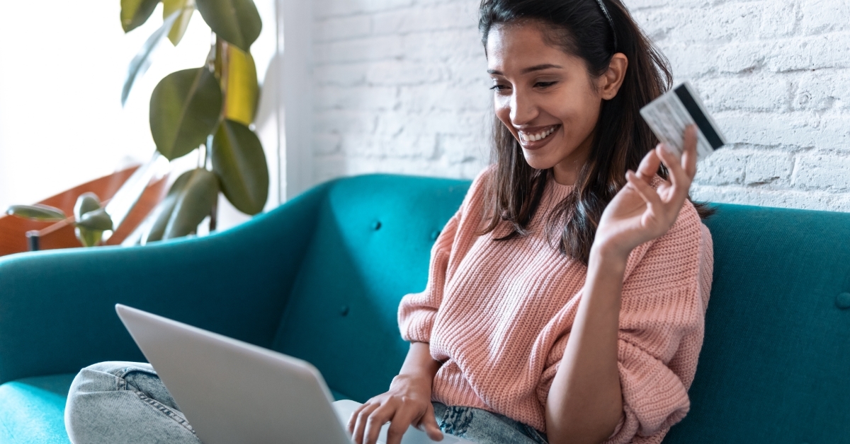 young woman shopping online with card