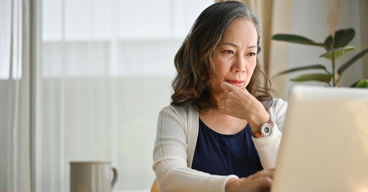 middle-aged-teacher-using-laptop