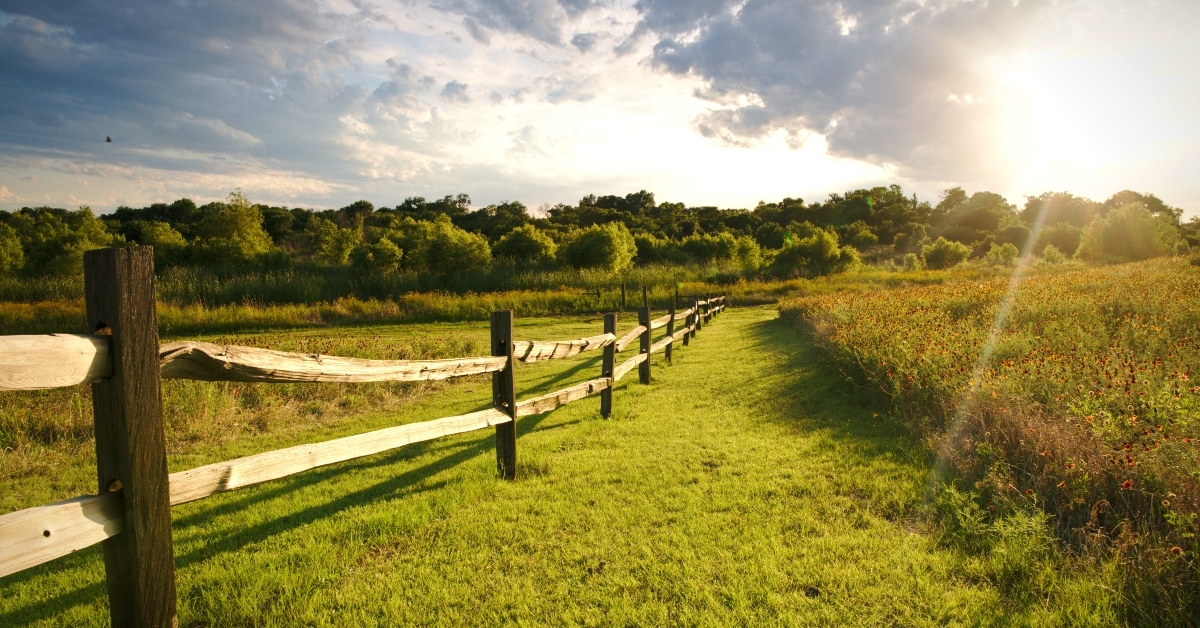 sun sets over a ranch fence in north texas