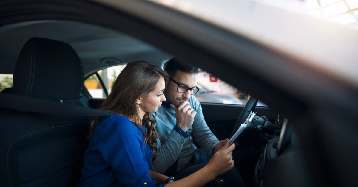 couple sitting inside new car