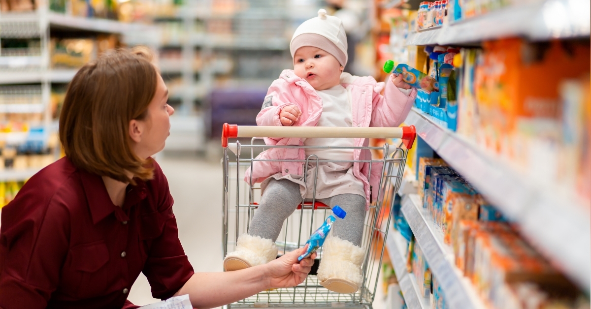 mother choosing baby food with baby