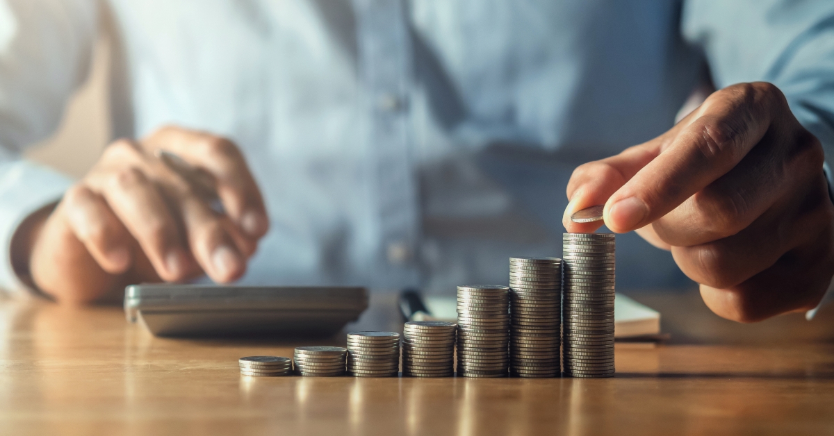 hand putting coins on stack