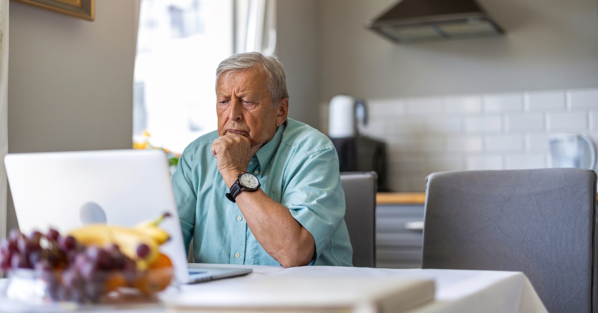 elderly man using laptop