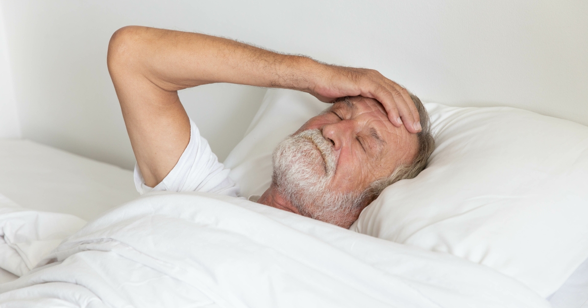 man lying awake in bed