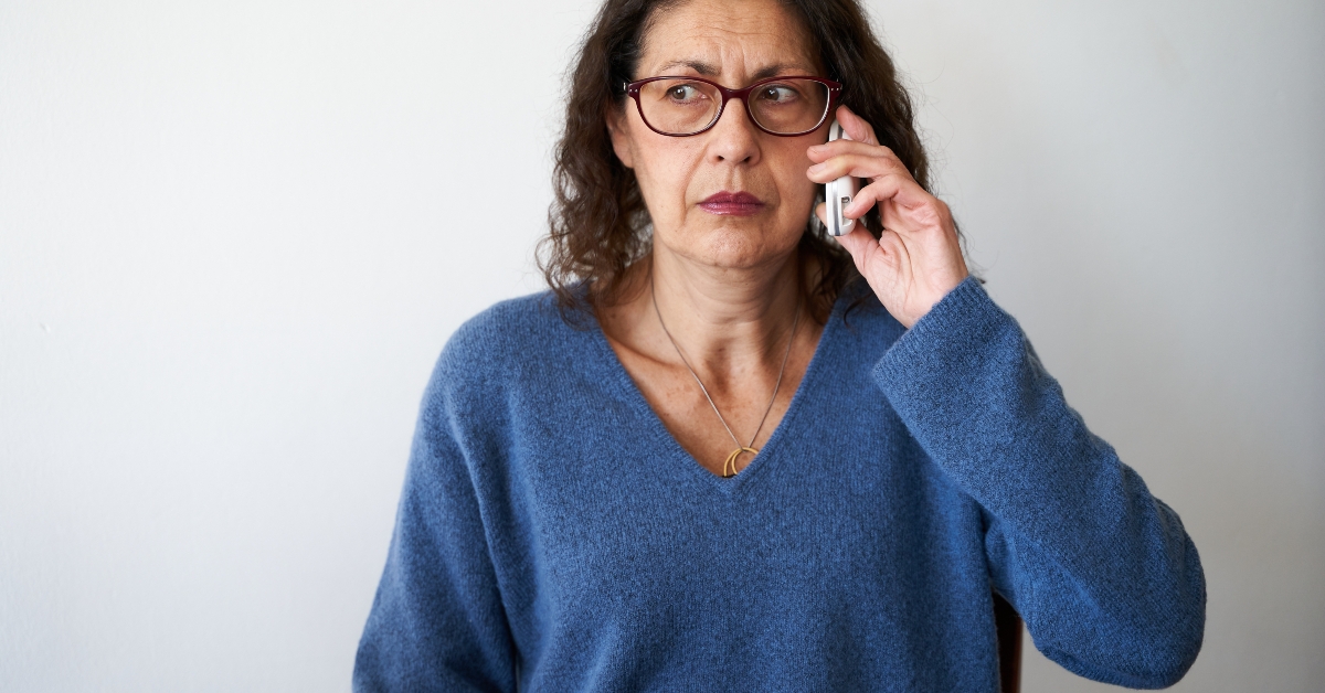 mature woman distrusting phone call