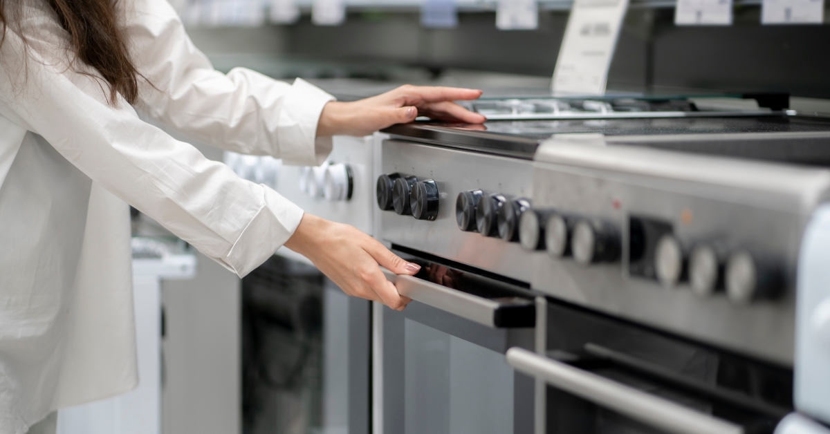 woman buying cooking range in store