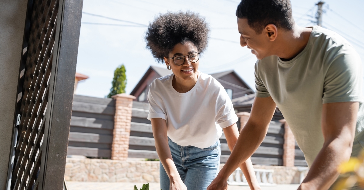 african american couple unpacking boxes together