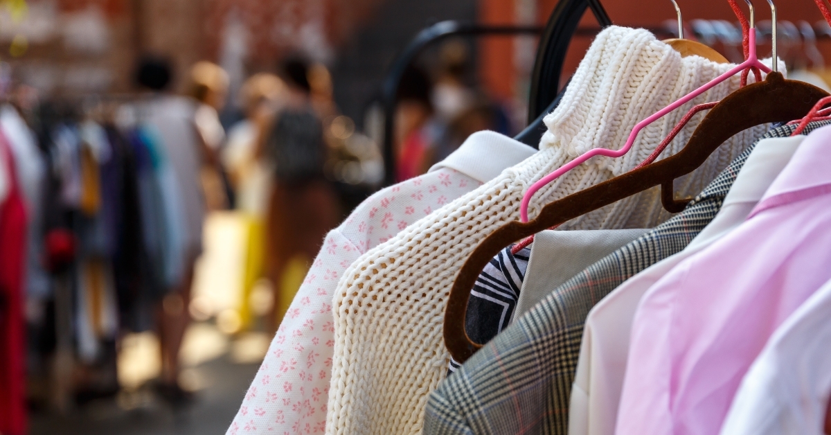 hangers with clothing at garage sale