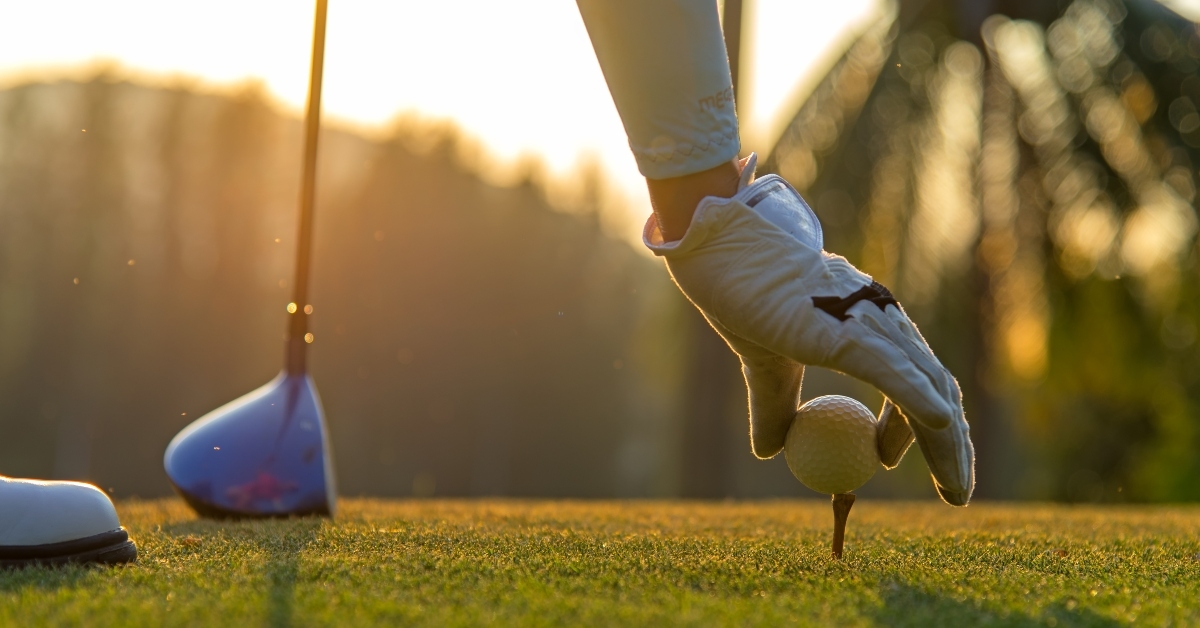 putting golf ball on tee
