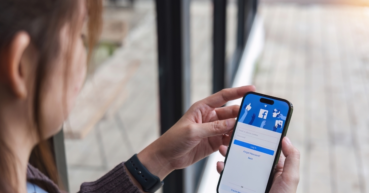 woman using facebook on smartphone