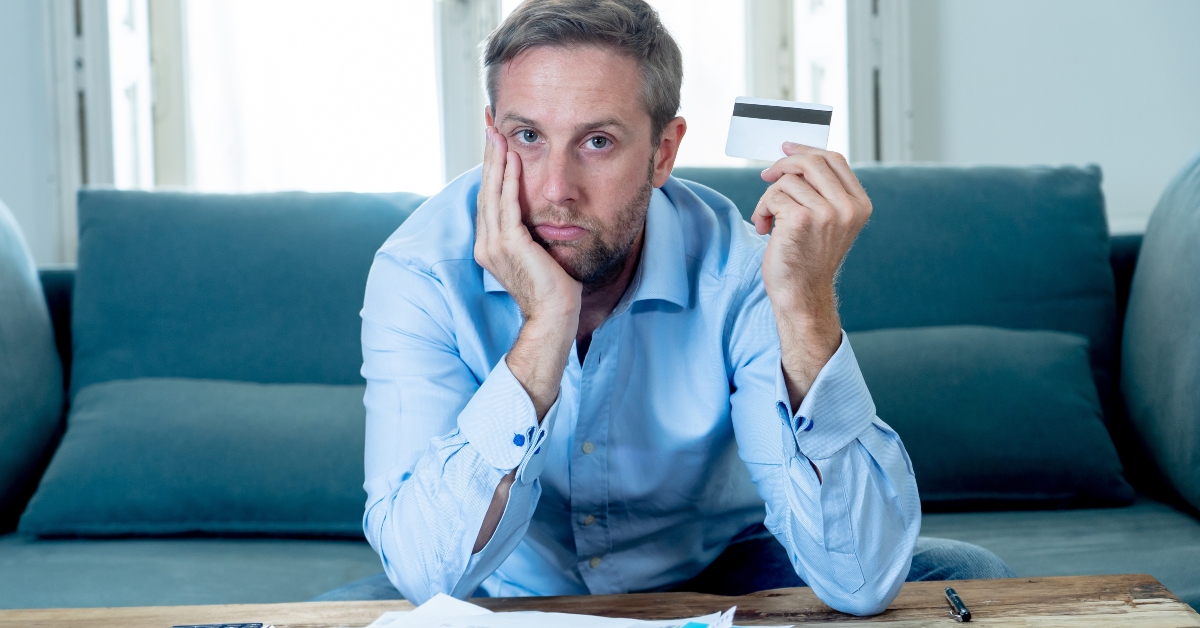 upset man paying debts