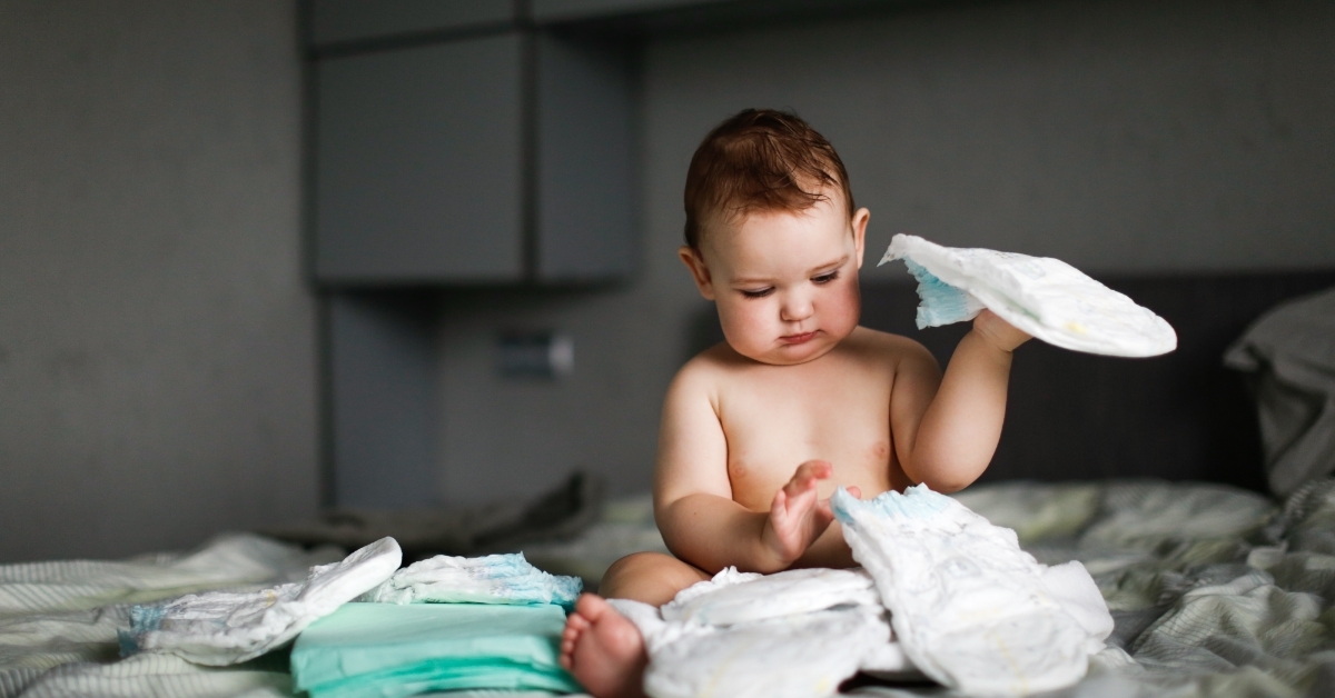 chubby baby sitting with disposable diapers