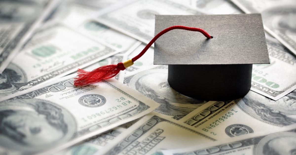 graduation hat on banknotes education concept