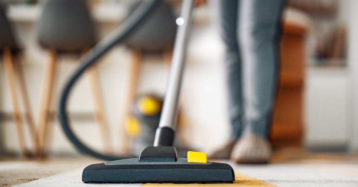 Housewife with vacuum cleaner