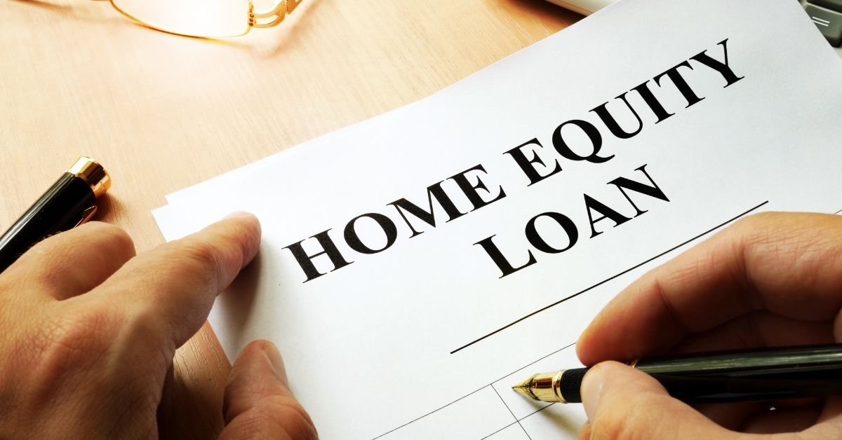 man filling home equity loan form