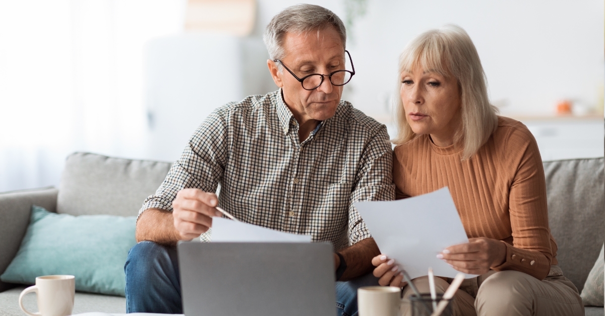 senior couple reading bills at home
