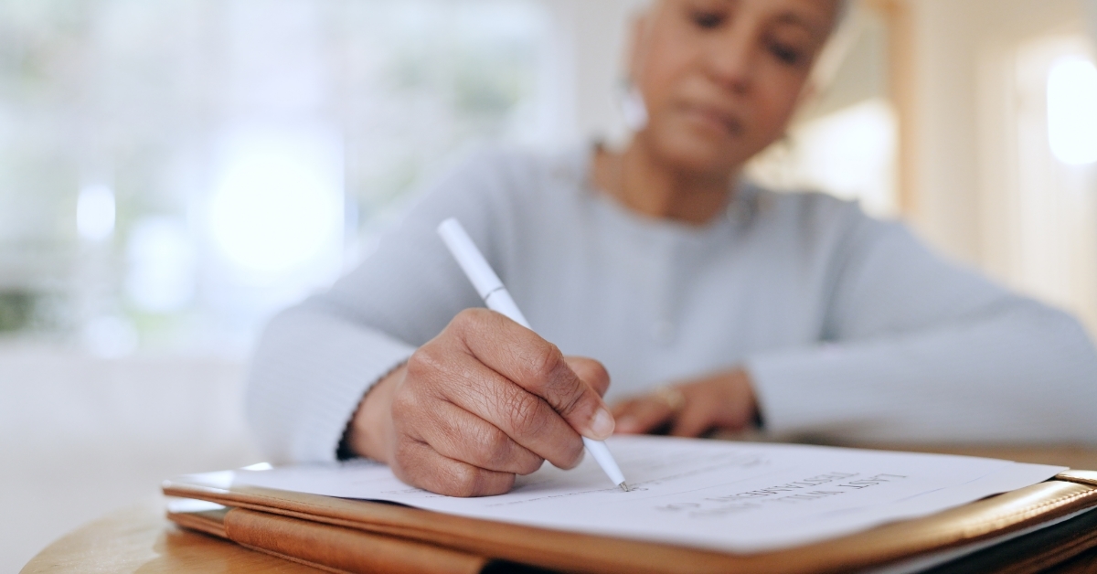 senior woman signing documents