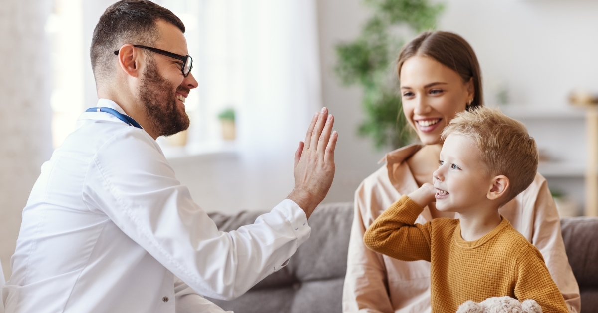 pediatrician cheering up child patient