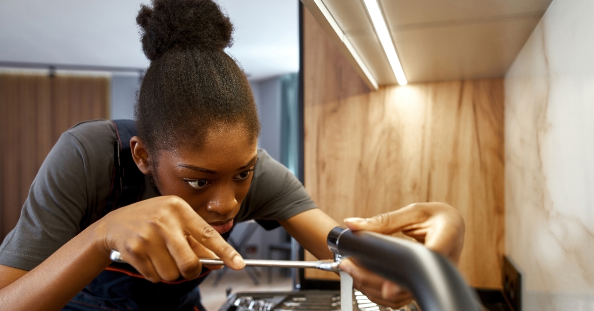african american woman working as plumber