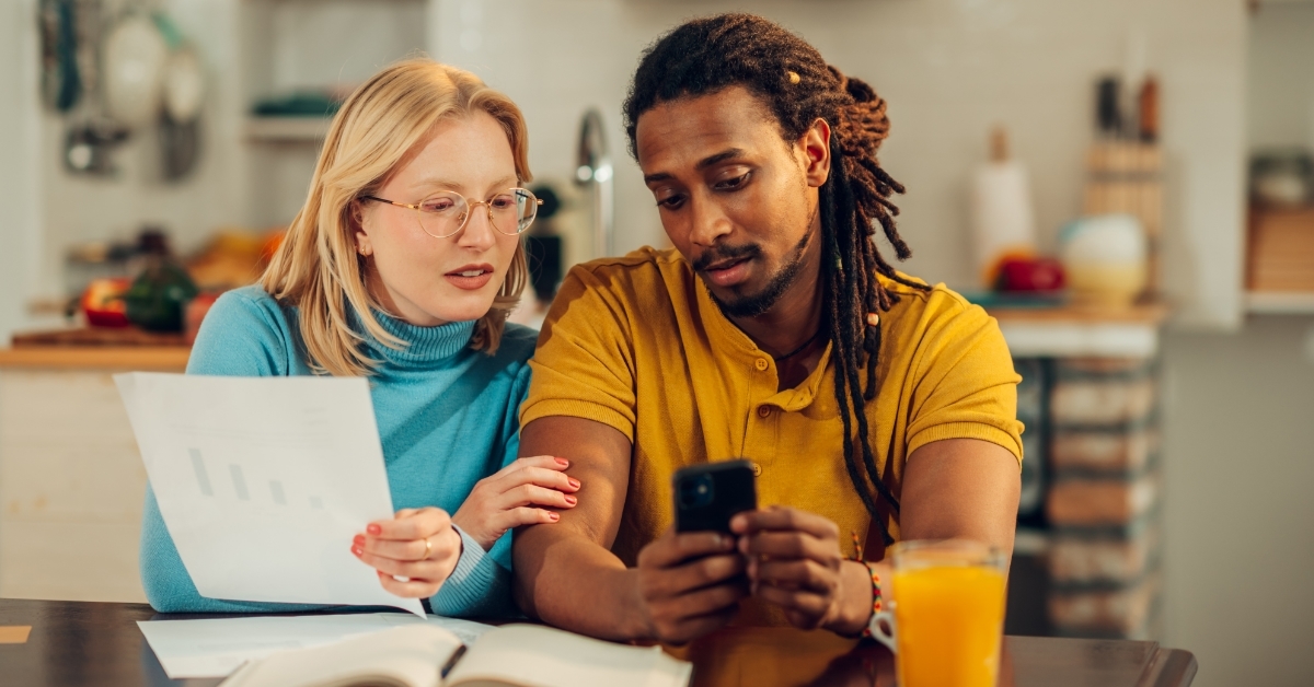 multicultural couple planning budget together
