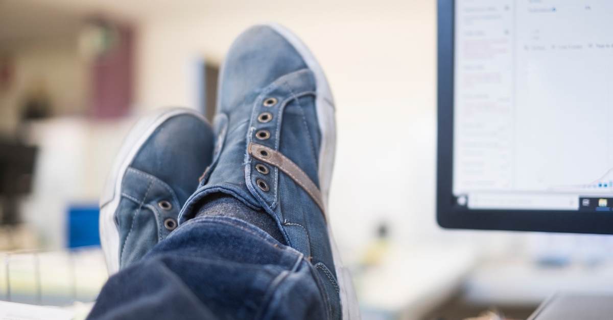 clerk resting foot on office table