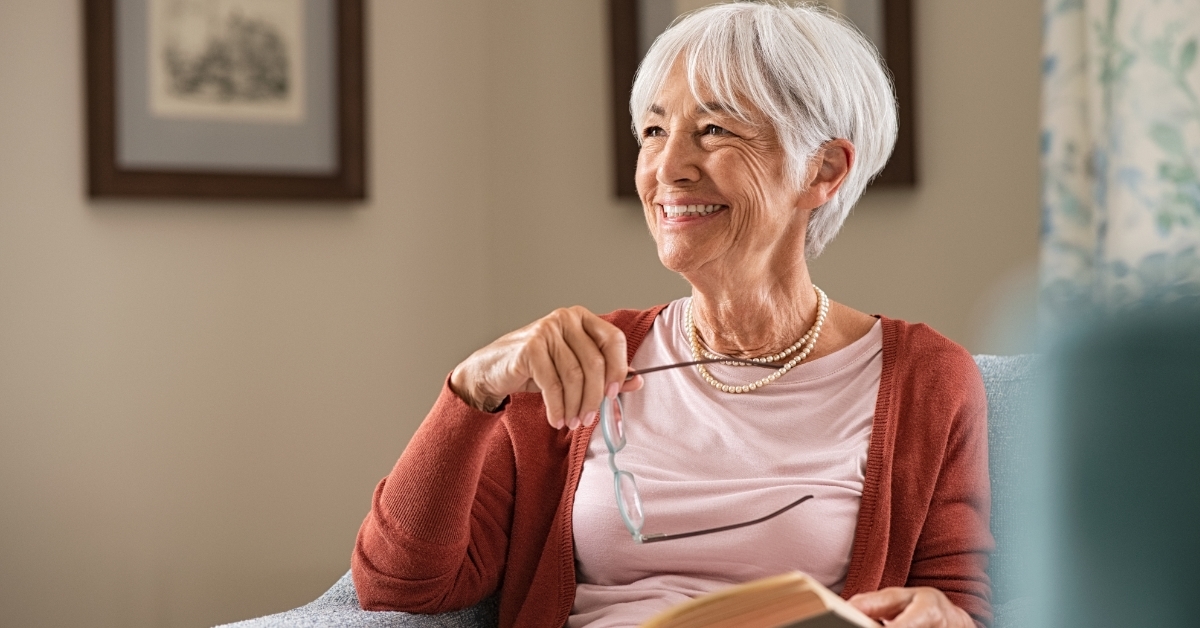 senior woman reading book at home