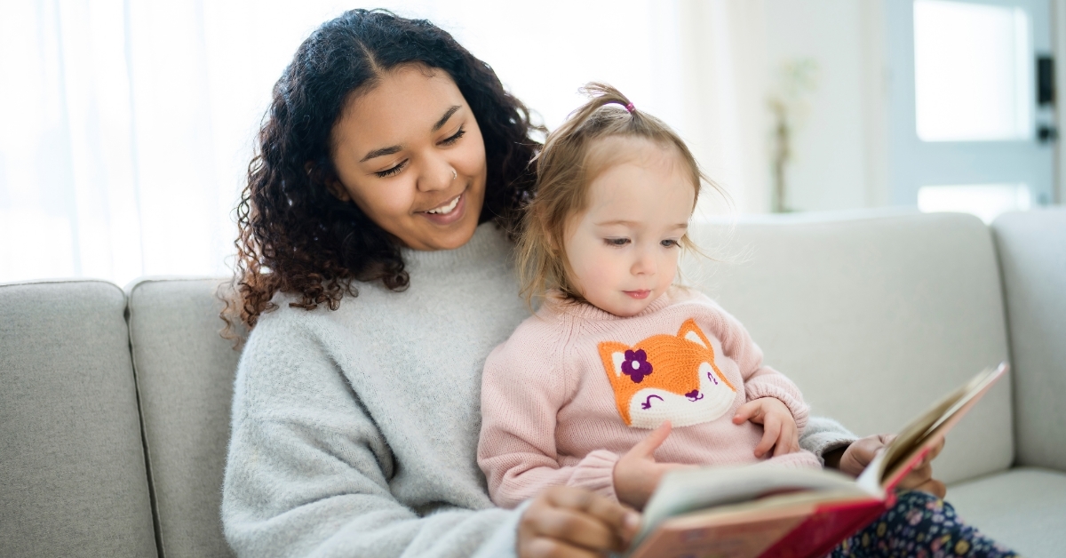babysitter reading book to baby girl