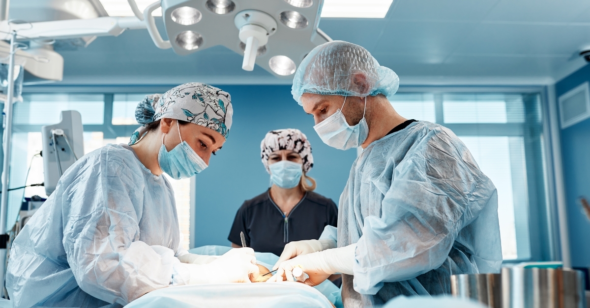 Doctors performing abdominoplasty surgery