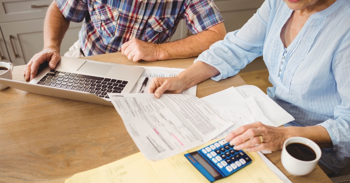 senior couple checking their bills