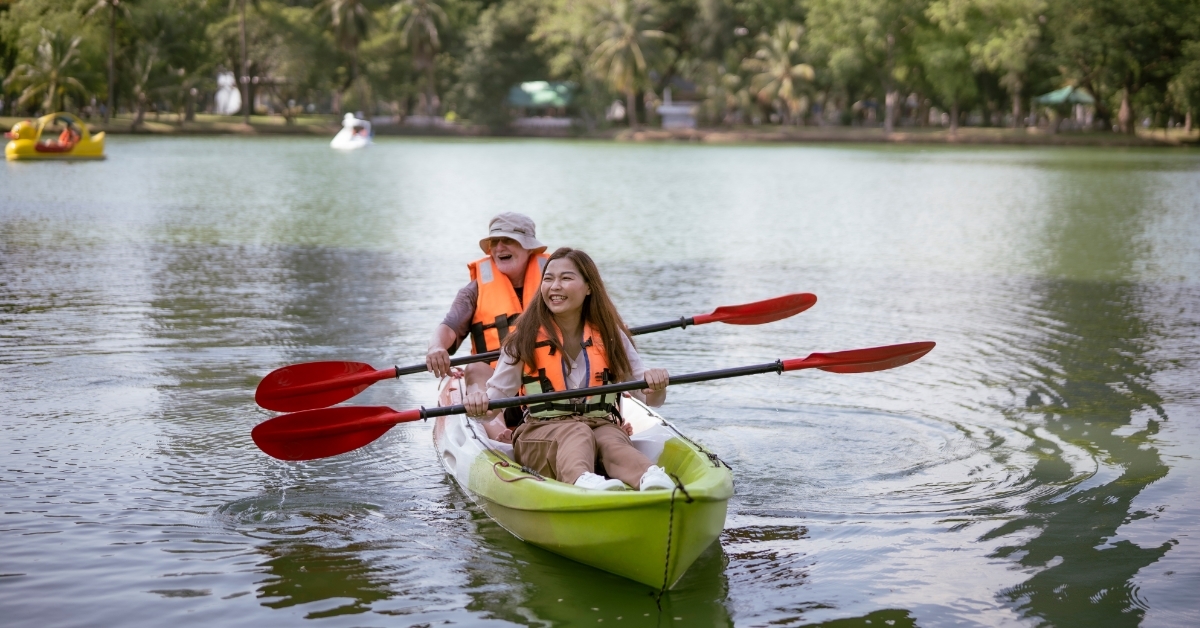 happy couple doing kayak in water