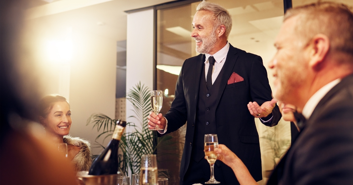senior businessman toasting champagne