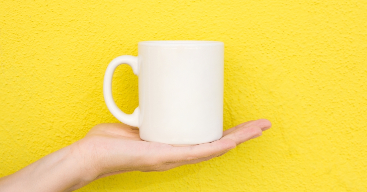 woman holding cup on yellow background