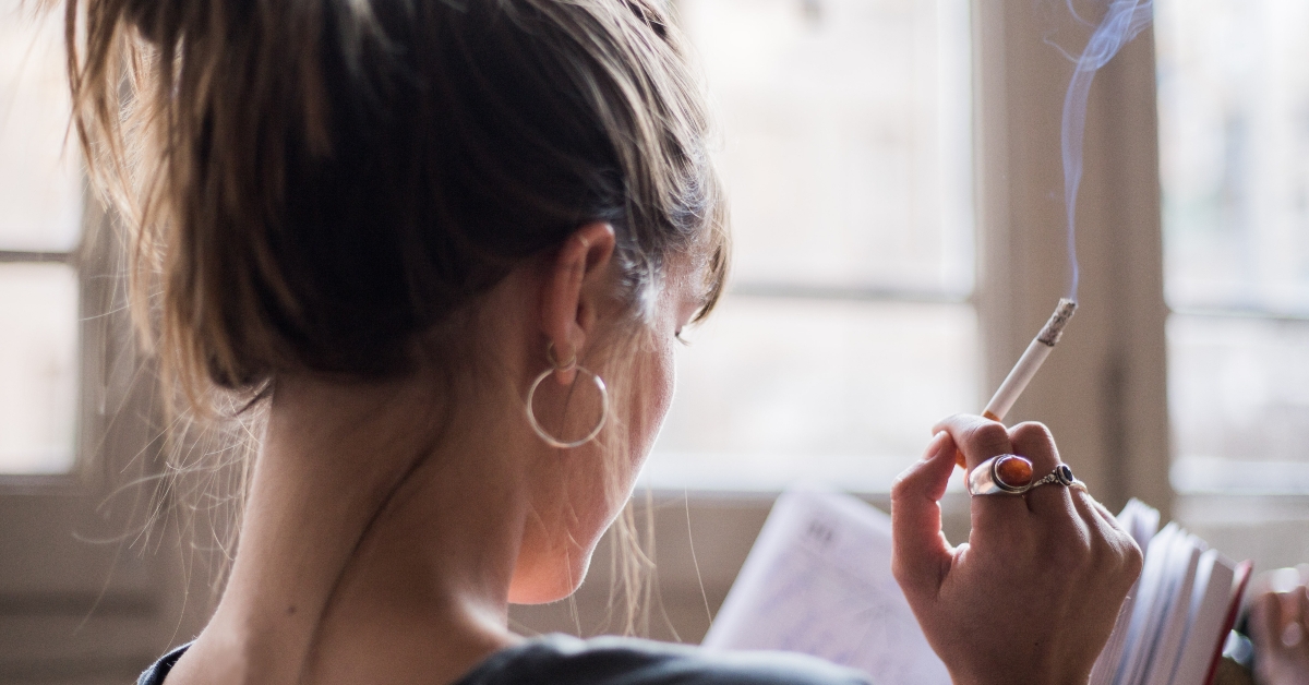 woman smoking and reading