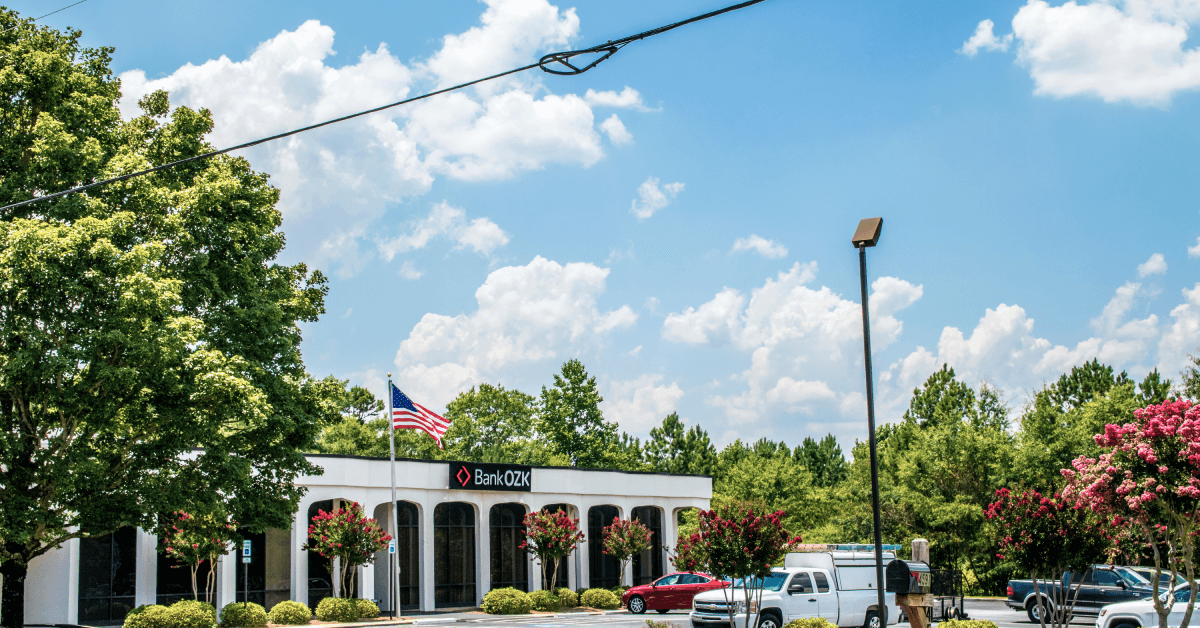 The Bank of the Ozarks with an American Flag and blue sky.