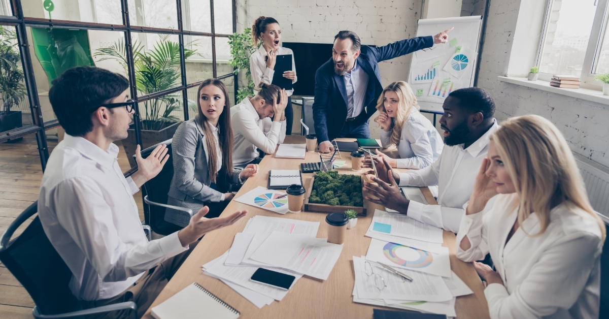 boss yelling at employee in meeting