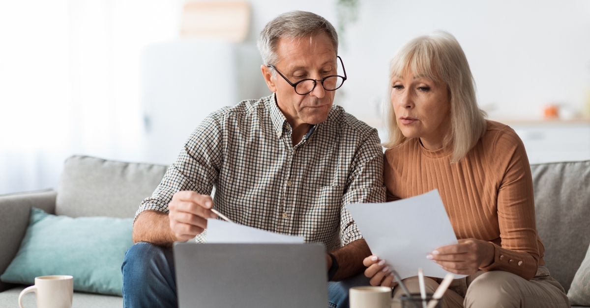 senior couple looking through papers