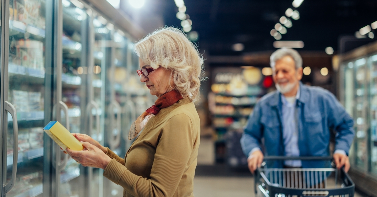 Senior couple choosing groceries in supermarket